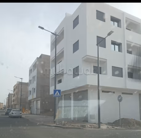 Three-story building with two shops
