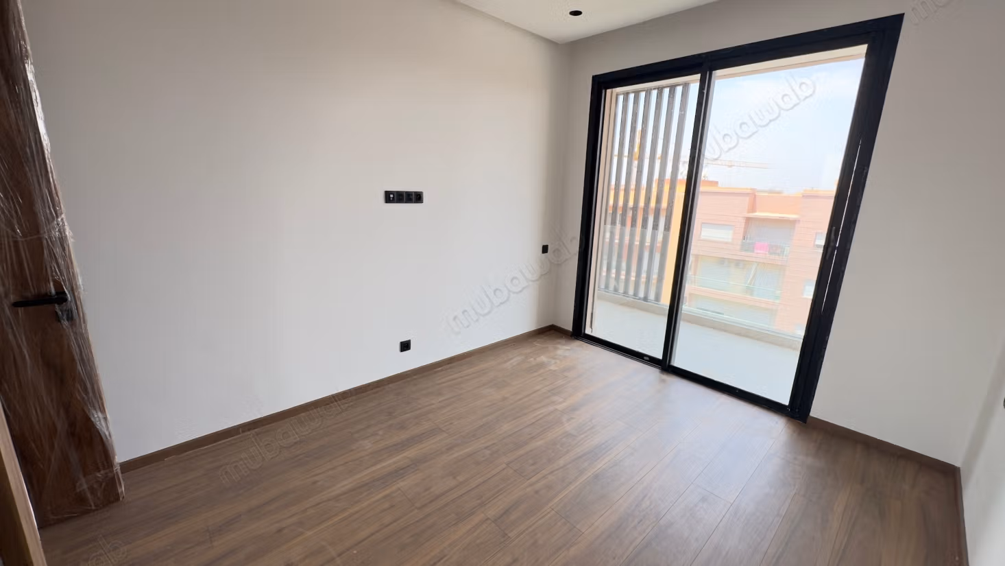Empty one-bedroom apartment in residential complex with pool