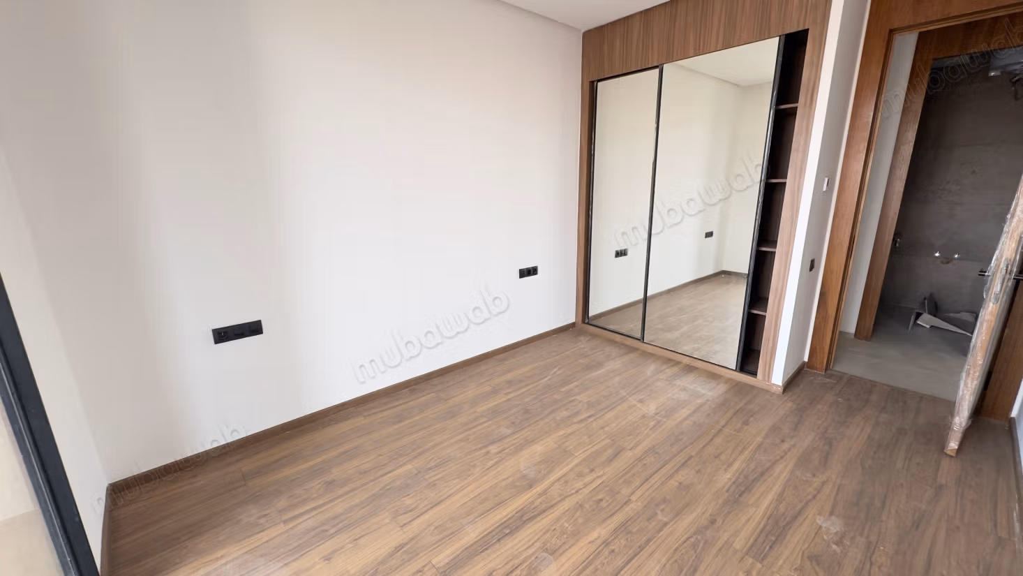 Empty one-bedroom apartment in residential complex with pool