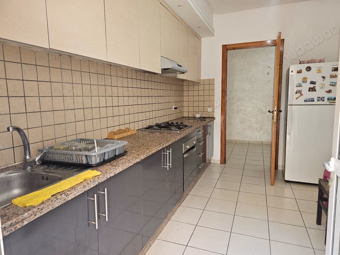Rent this apartment in Mimosas. 2 bedrooms. Traditional Moroccan living room, secure residence